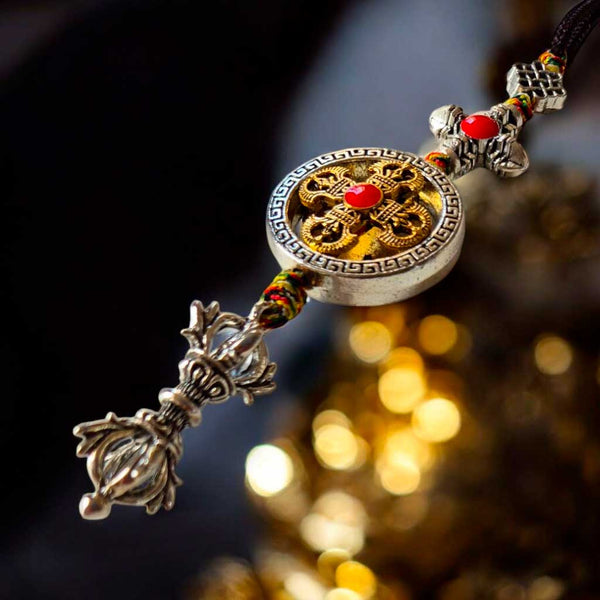Amulette bouddhiste tibétaine avec symbole doré et pierre rouge, artisanat de l'Himalaya