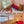 Chambre mezzanine bouddhiste avec lit rouge, drapeaux tibétains et vue jardin, idéale pour méditation