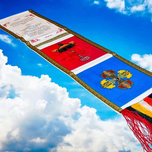 Drapeaux de prière tibétains colorés avec symboles bouddhistes, flottant dans le ciel bleu