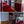 Couloir de centre bouddhiste avec tapis rouge et rideaux tibétains colorés, décoration spirituelle et accueil paisible