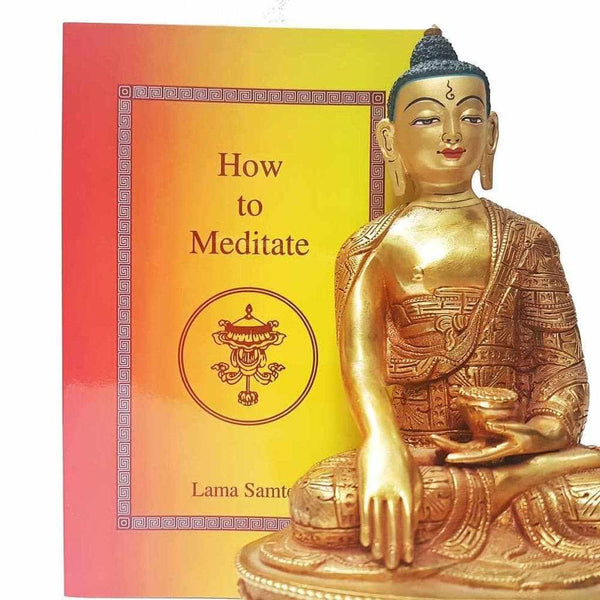 Statue dorée de Bouddha et livre 'How to Meditate' par Lama Samten, guide de méditation bouddhiste