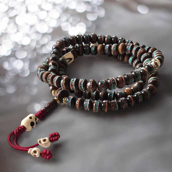 Chapelet bouddhiste tibétain en bois avec perles décorées et crânes, objet de méditation spirituelle
