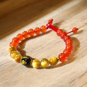 Bracelet bouddhiste en pierres naturelles avec perle noire dorée, symbole de sagesse et méditation