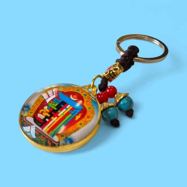 Porte-clés bouddhiste tibétain avec symboles sacrés, perles turquoise et rouges, artisanat de l'Himalaya