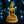 Statue dorée de Bouddha en méditation, style tibétain, sur socle orné, lumière bleue en arrière-plan