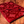 Coussin de méditation tibétain rouge à motifs floraux, tissu brodé, posé sur bois