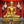 Statue dorée de Bouddha en méditation, décor tibétain et objets sacrés sur fond rouge