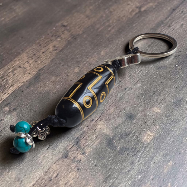 Porte-clés bouddhiste tibétain avec perle noire dorée et turquoise, symbole de protection et sagesse